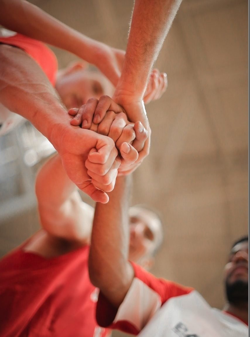 Basketball team stacking hands together 3755440 (1)